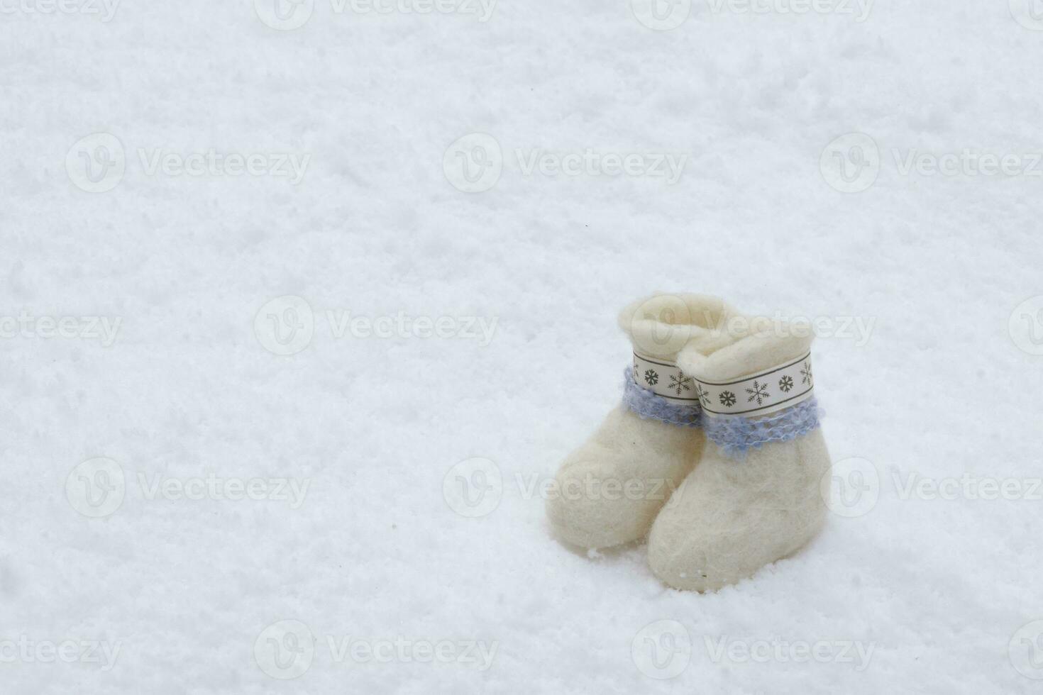cute little white boots stand on pure snow. selective focus.High quality photo