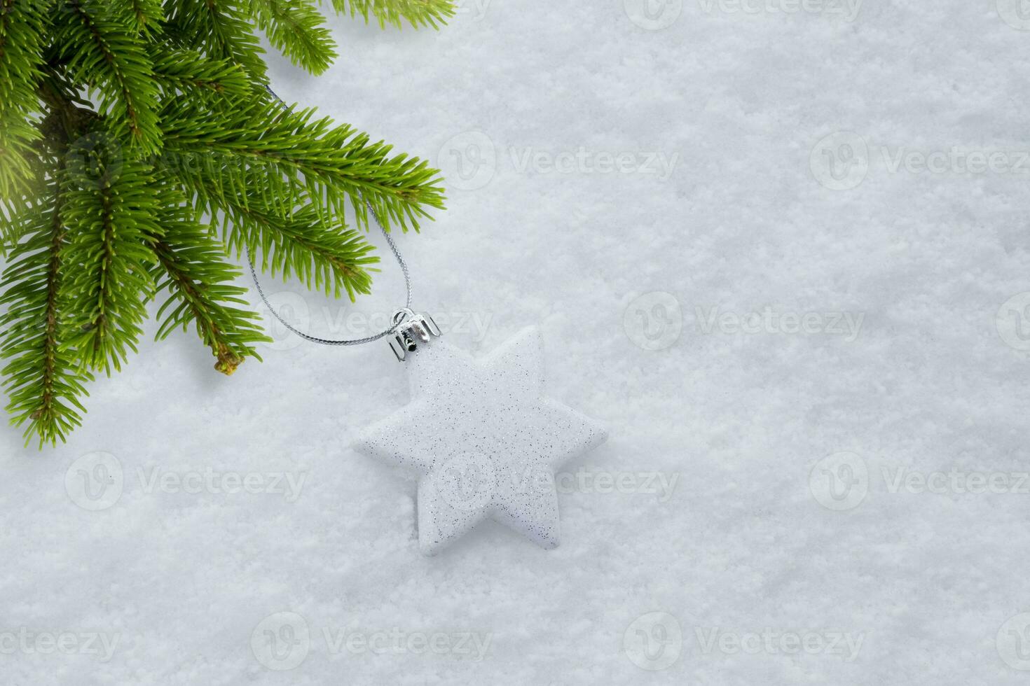 The decoration with the Christmas tree lies on the snow next to the christmas tree. High quality photo