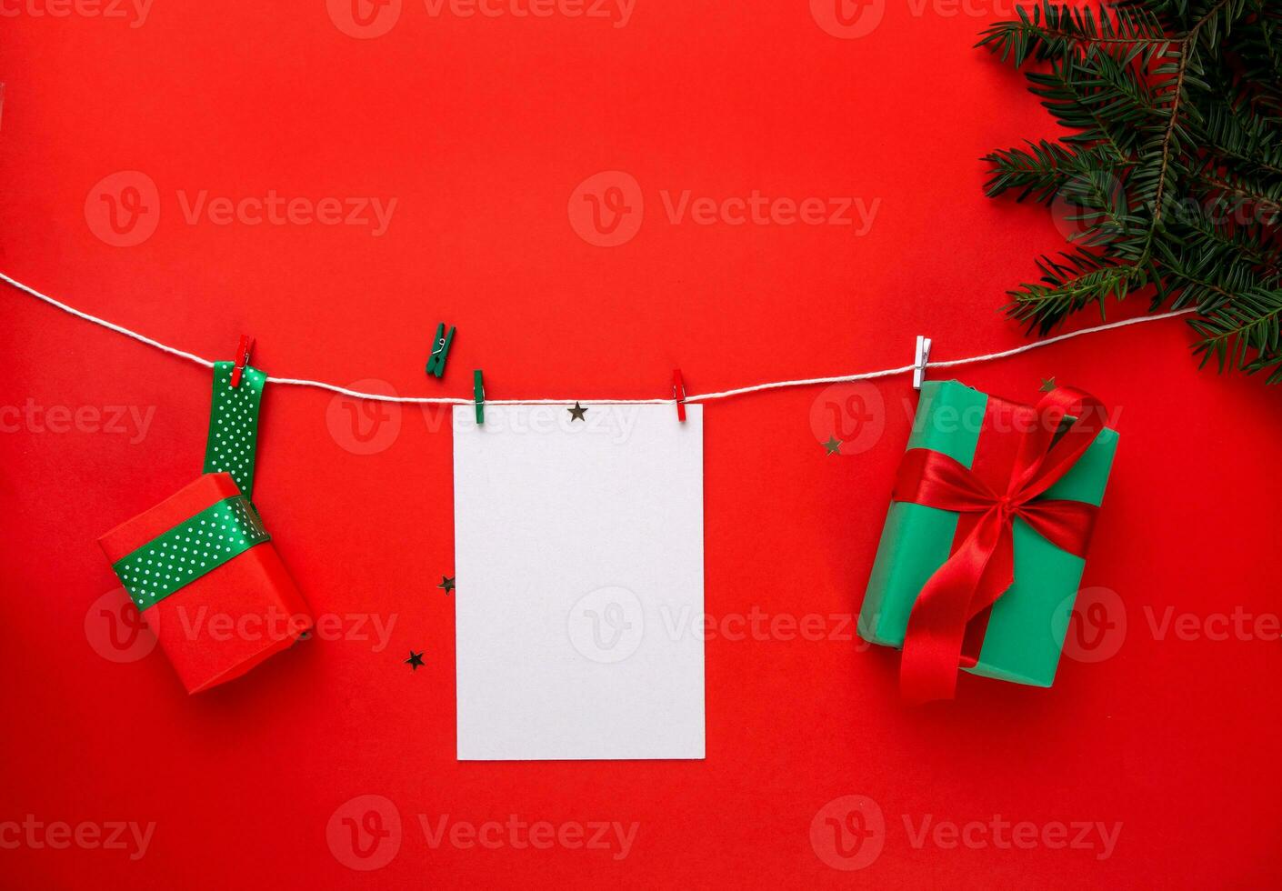 white sheet of paper and a box with a gift on a white string. photo