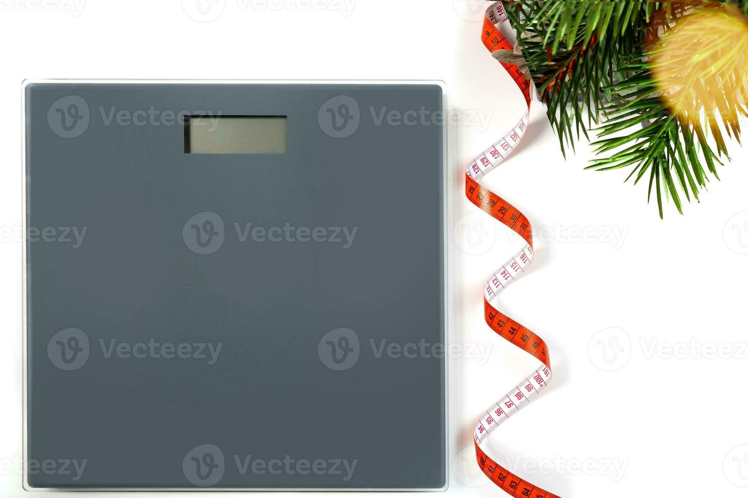 scales, flexible meter and Christmas tree branch with bokeh garland on the white background. selective focus.High quality photo