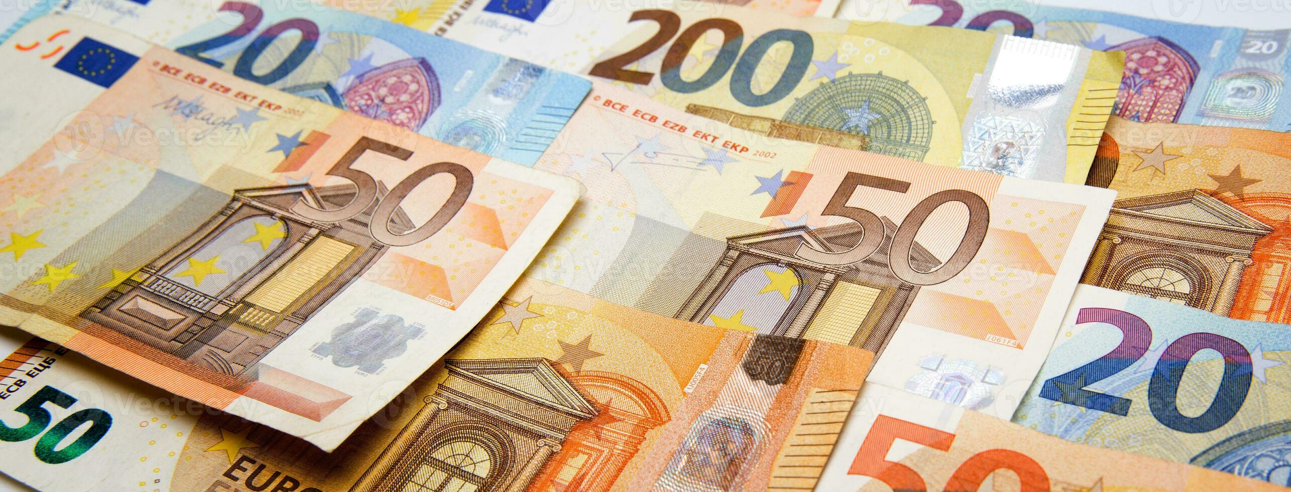euro currency banknotes of different denominations are laid out on each other on the table. selective focus.High quality photo