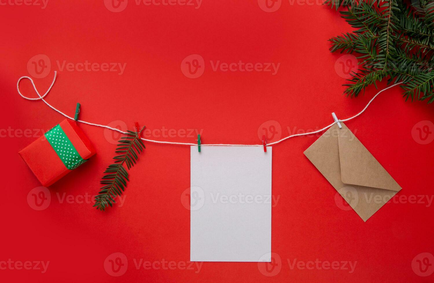 Christmas garland on a red background with green branches. Christmas composition . flat lay photo