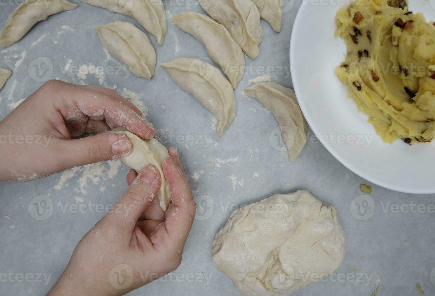 the hands of a child who learns to make dumplings with potatoes. selective focus. photo