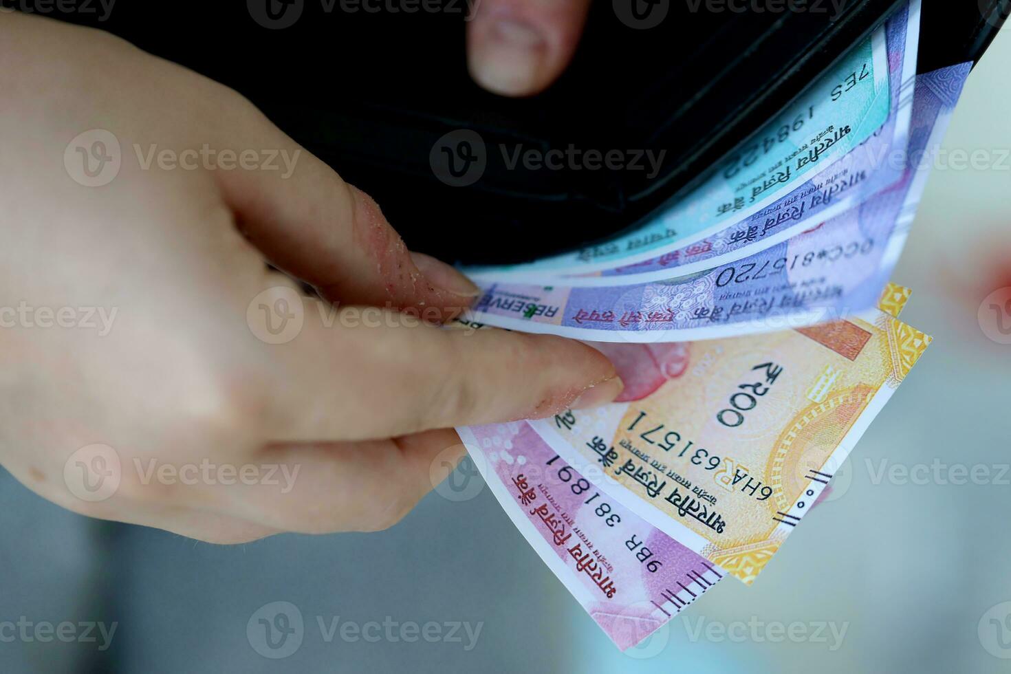 Woman hand with indian rupees bills. Concept of financial operations in cash in India photo