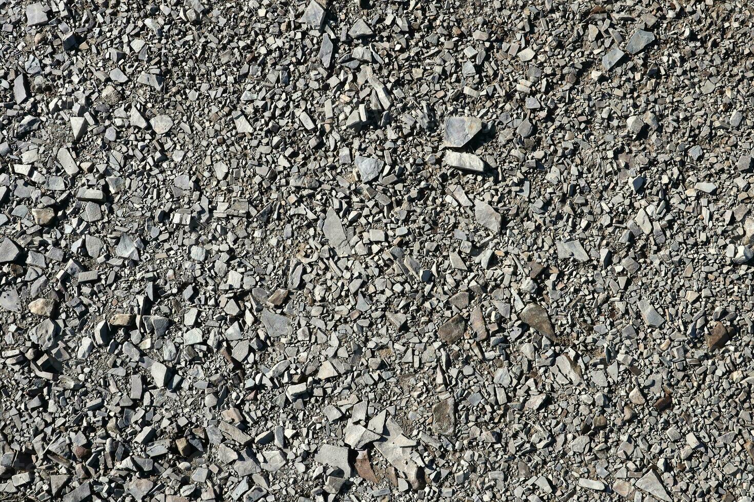 Background of shattered stony stones surface in mountain area. Texture with natural light photo