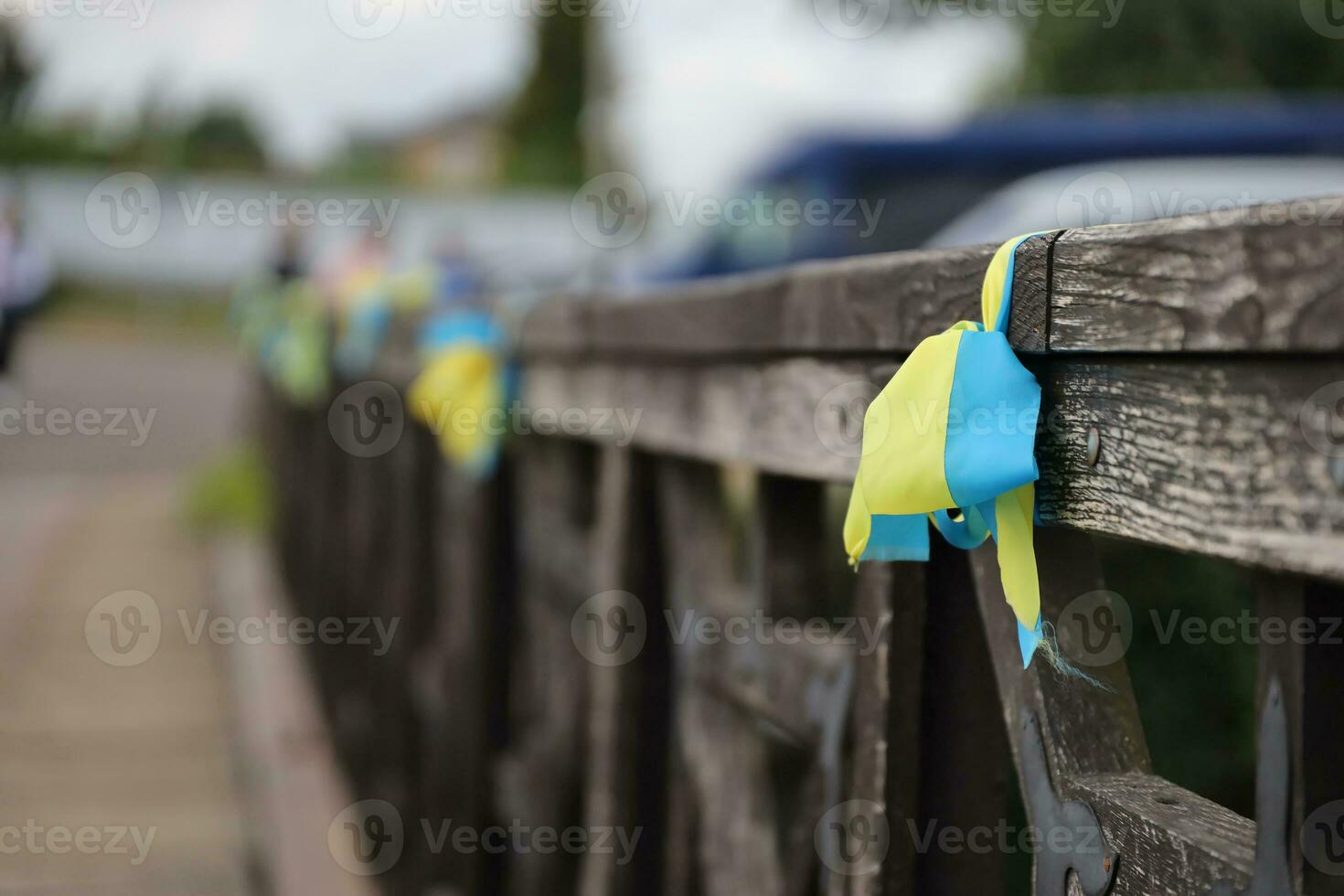 Ribbons in the colors of the national flag of Ukraine are tied to the handrail photo