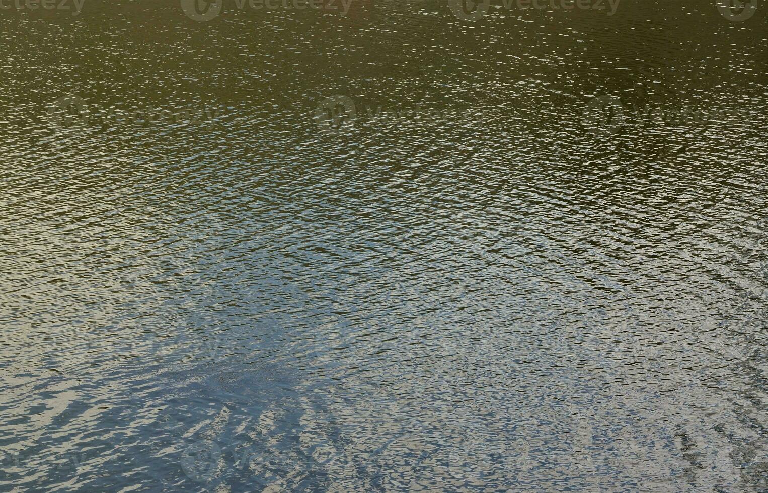 The texture of dark river water under the influence of wind, imprinted in perspective. Horizontal image photo