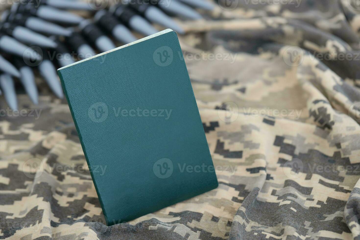 Ukrainian military ID on fabric with texture of pixeled camouflage. Cloth with camo pattern in grey, brown and green pixel shapes with Ukrainian army personal token photo