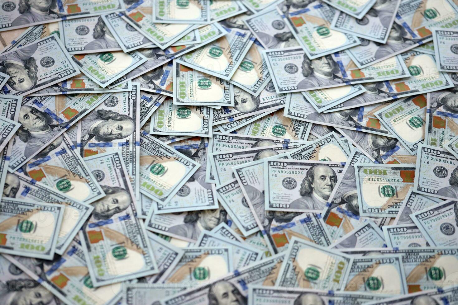 Very big amount of US hundred dollar bills. Huge quantity of united states currency notes on flat table photo