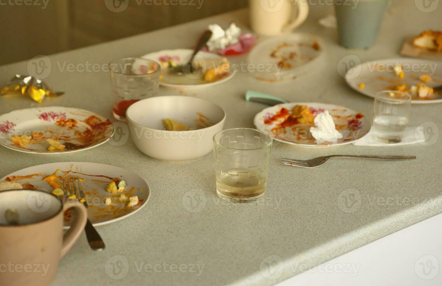 Empty dirty plates with spoons and forks on the table after meal. Banquet ending concept. Unwashed dishes photo