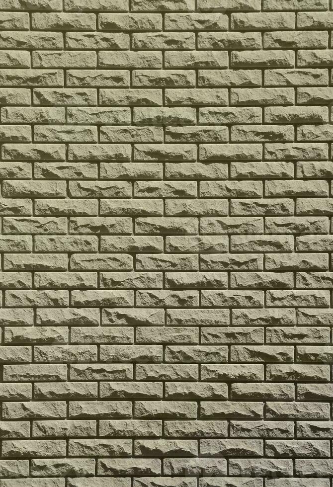 Texture of brick wall from relief stones under bright sunlight photo