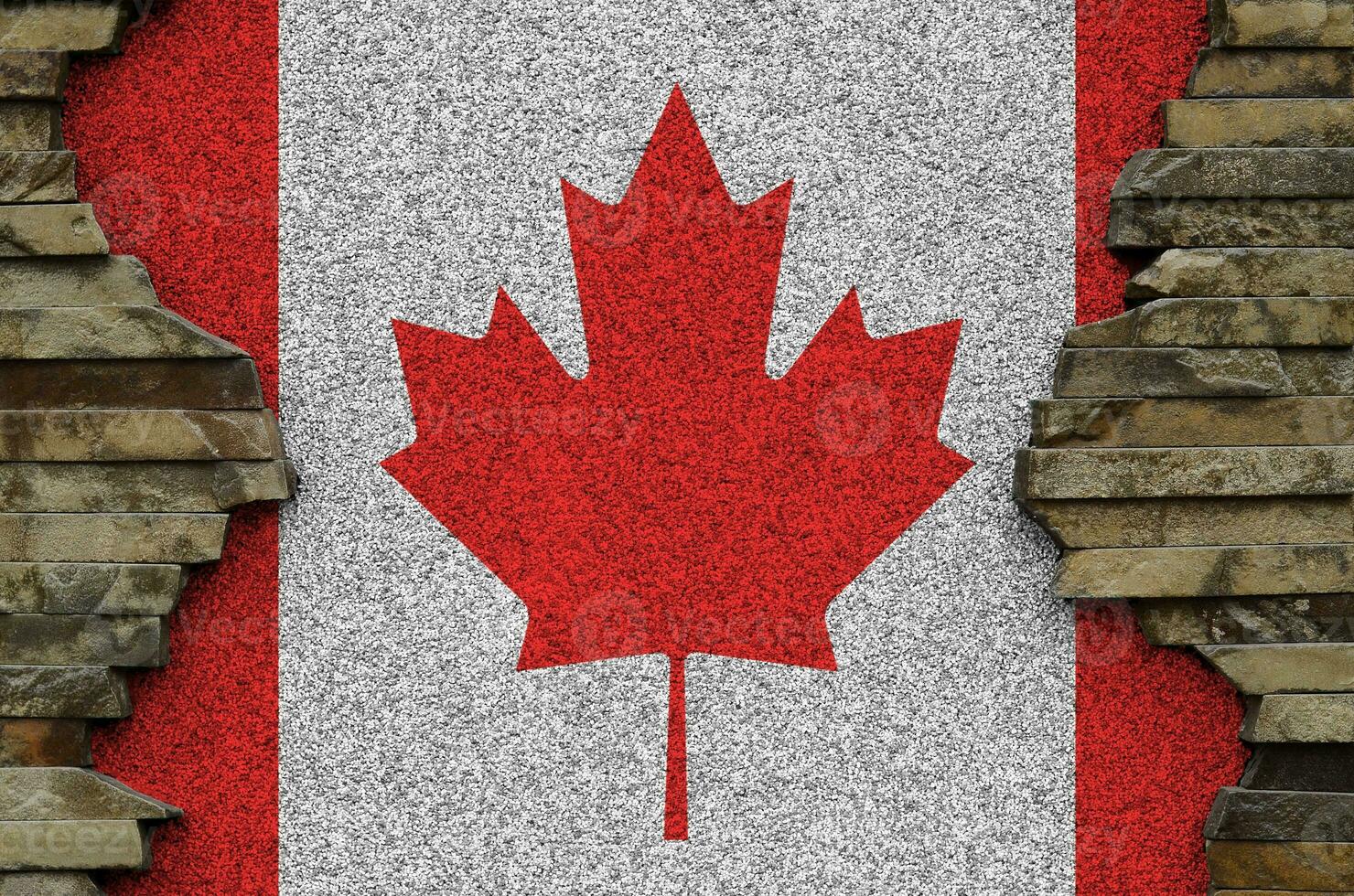 Canada flag depicted in paint colors on old stone wall closeup. Textured banner on rock wall background photo