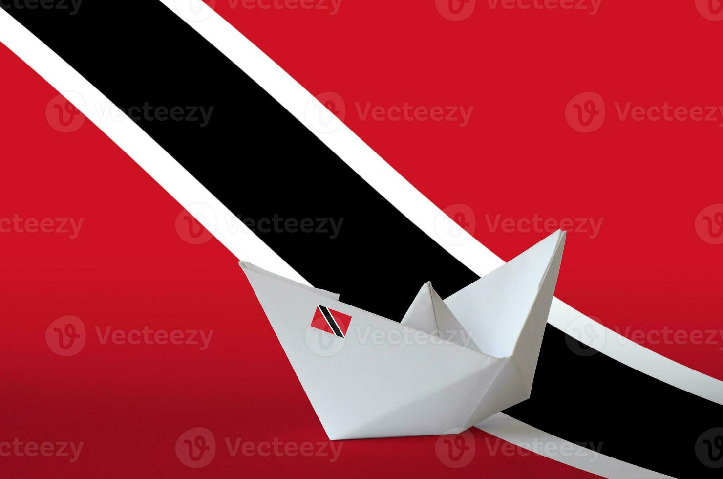 Trinidad and Tobago flag depicted on paper origami ship closeup. Handmade arts concept photo