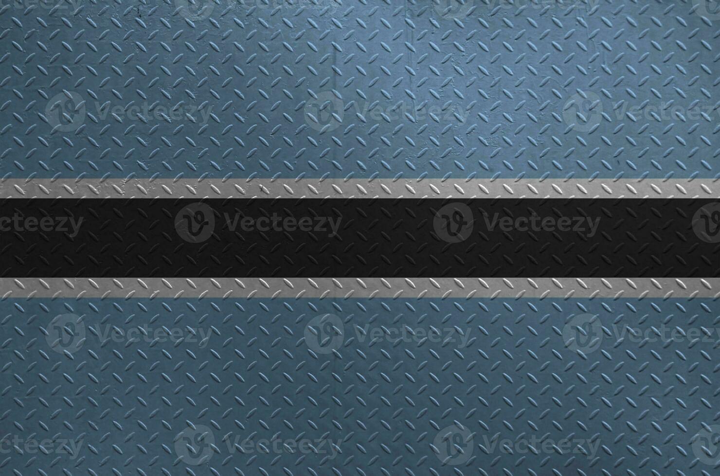 Botswana flag depicted in paint colors on old brushed metal plate or wall closeup. Textured banner on rough background photo
