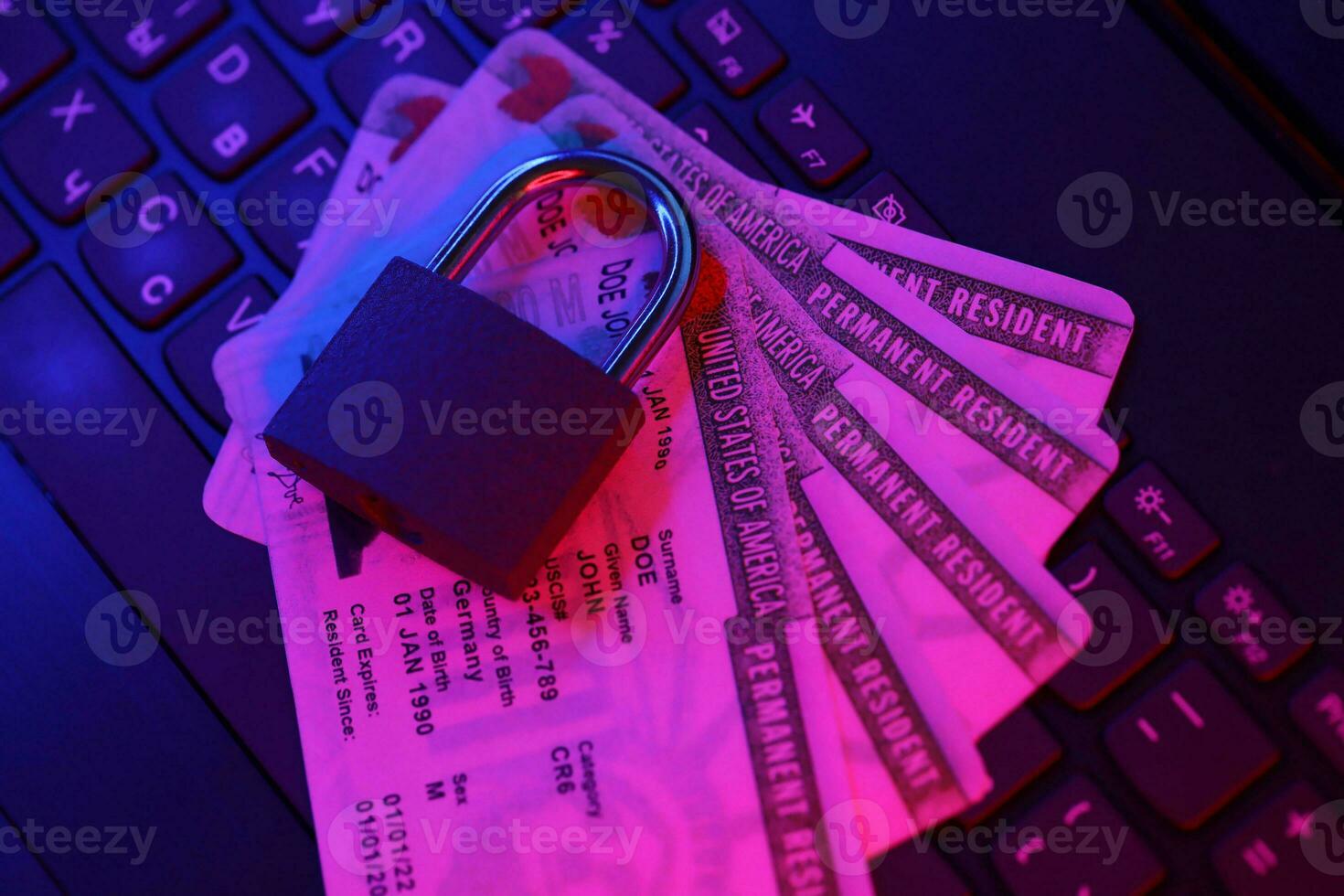 Permanent resident green card for US DV-lottery with small padlock on computer keyboard photo