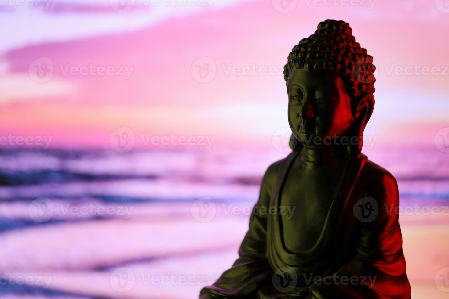 Buddha Purnima and Vesak day concept, Buddha statue with low key light against beautiful and colorful background. Meditation photo