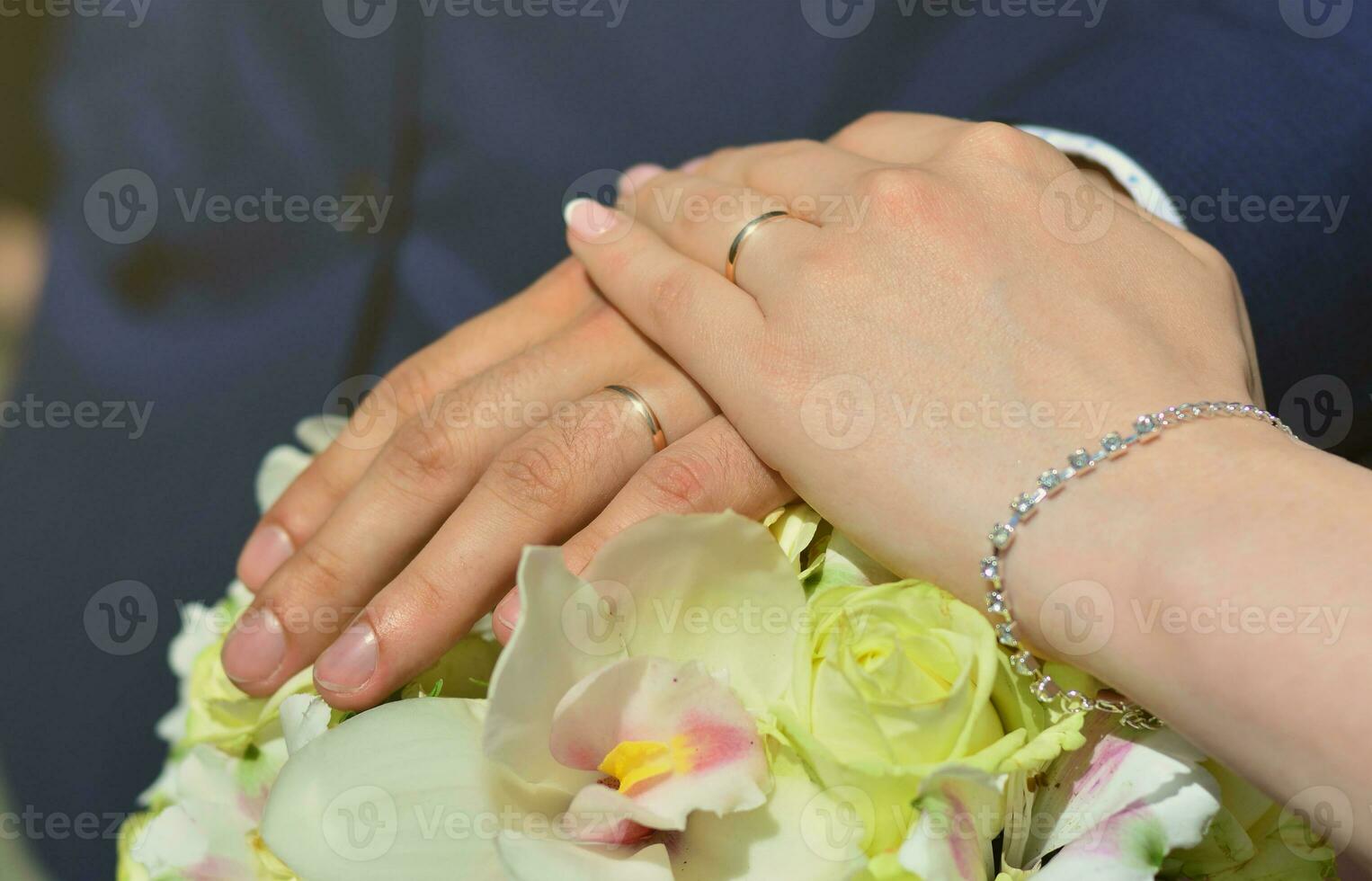 The newlywed couple is holding a beautiful wedding bouquet. Classical wedding photography, symbolizing unity, love and the creation of a new family photo