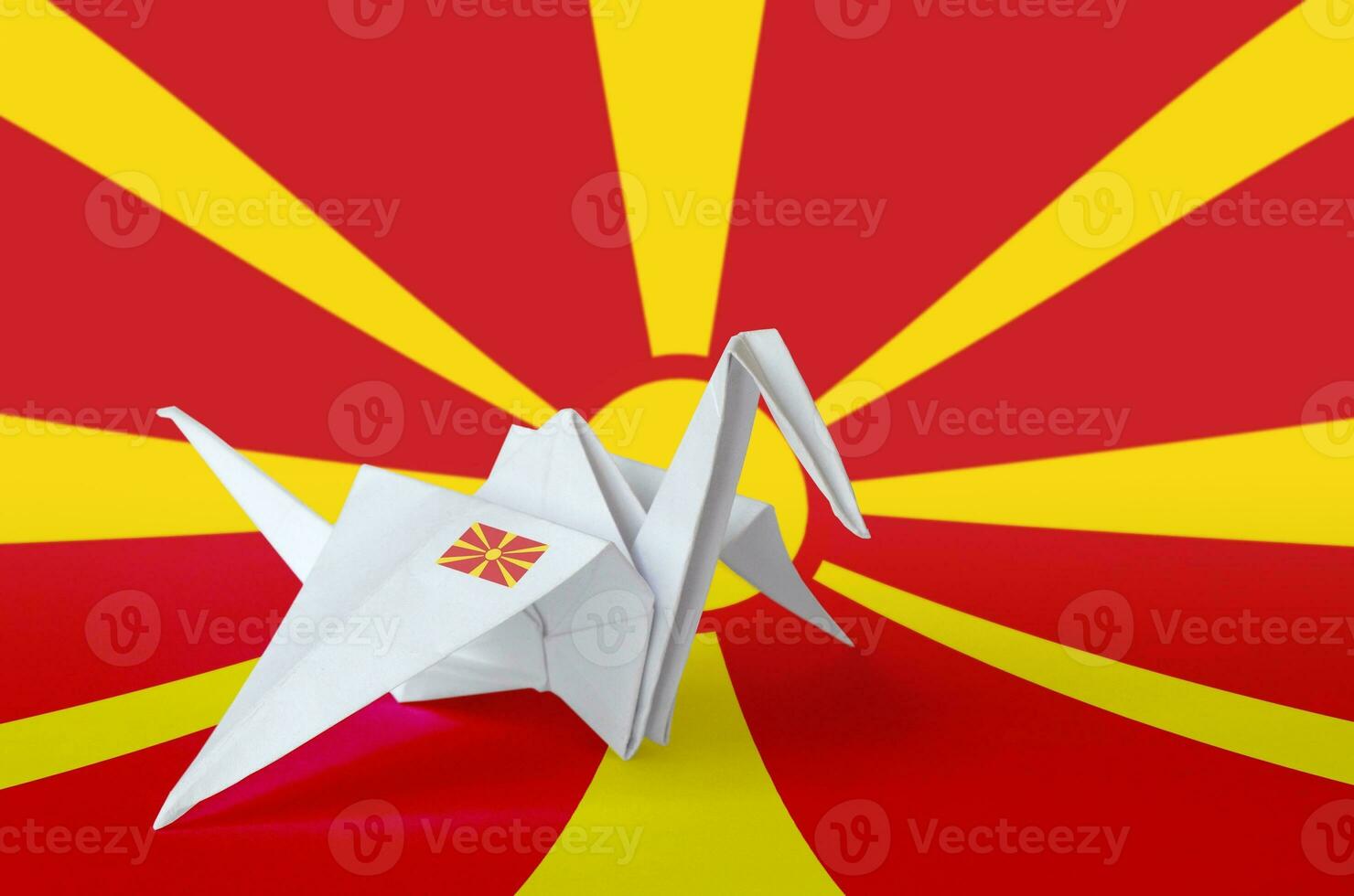 Macedonia flag depicted on paper origami crane wing. Handmade arts concept photo