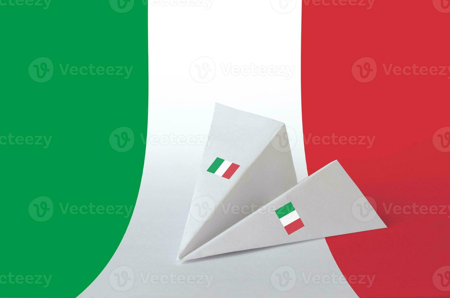 Italy flag depicted on paper origami airplane. Handmade arts concept photo