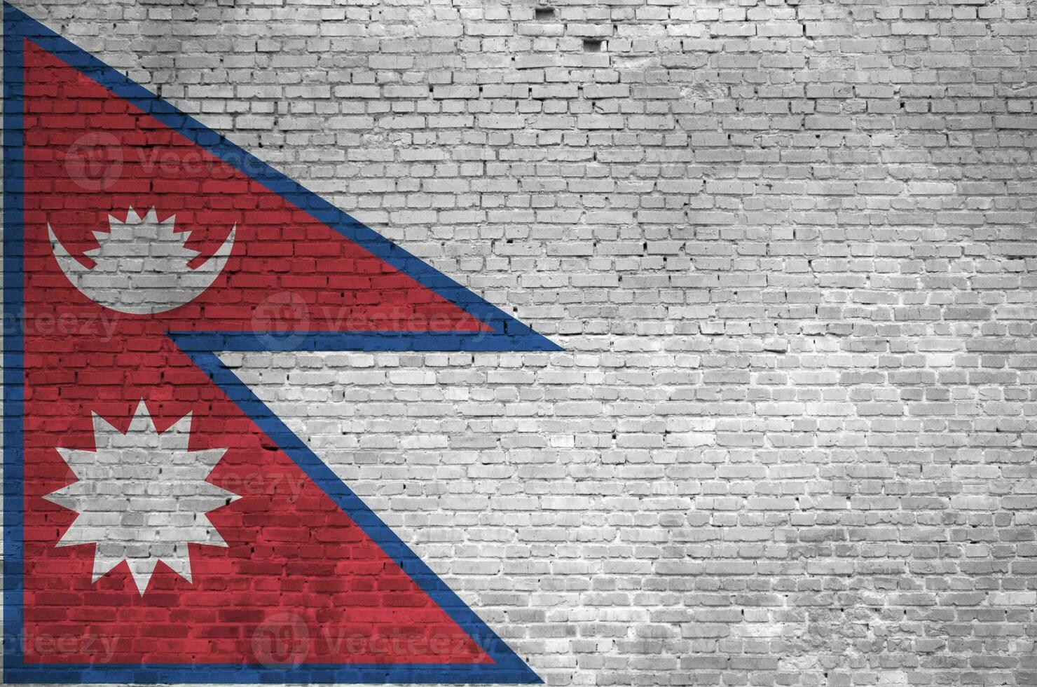 Nepal flag depicted in paint colors on old brick wall. Textured banner on big brick wall masonry background photo