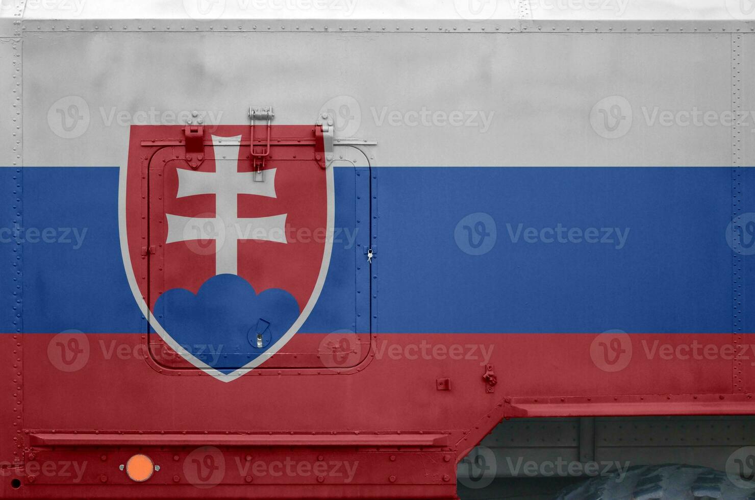 Slovakia flag depicted on side part of military armored truck closeup. Army forces conceptual background photo