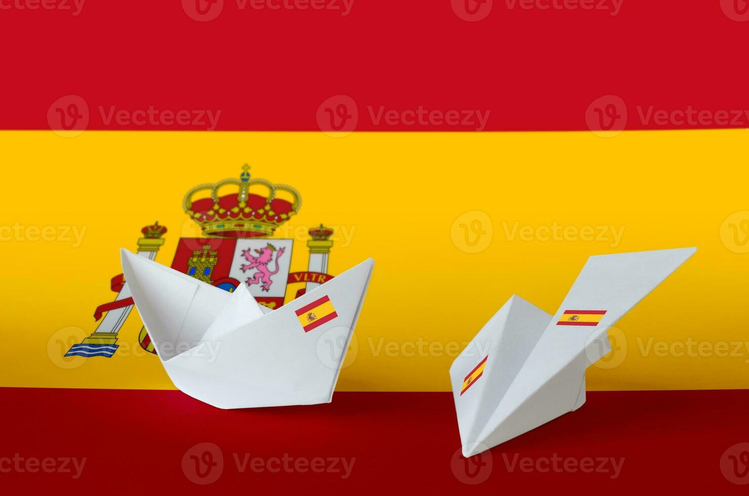 Spain flag depicted on paper origami airplane and boat. Handmade arts concept photo