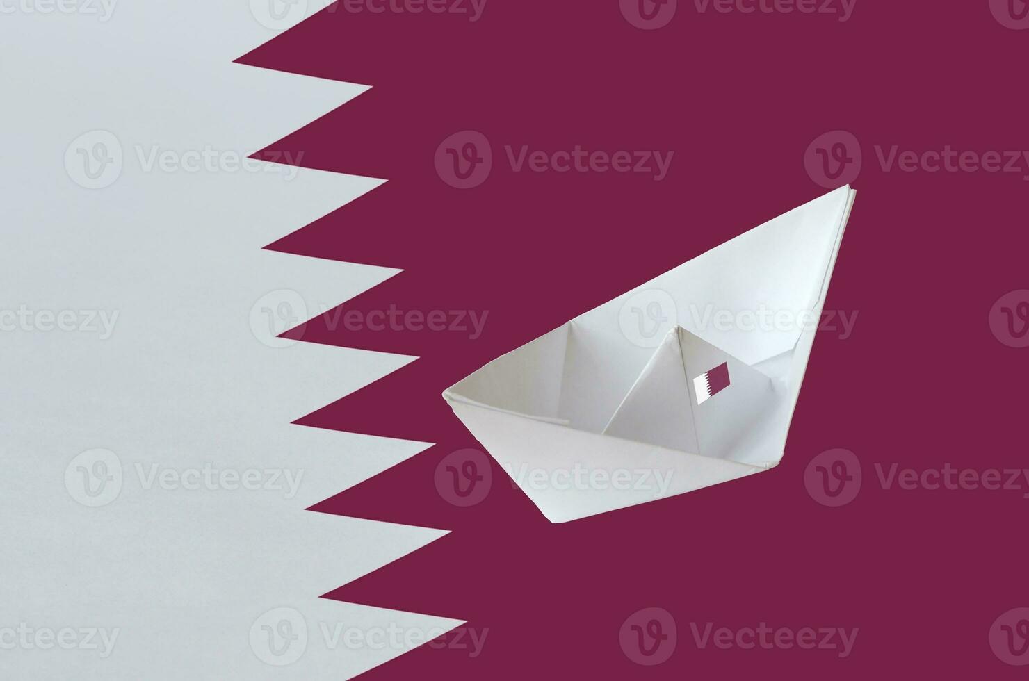 Qatar flag depicted on paper origami ship closeup. Handmade arts concept photo