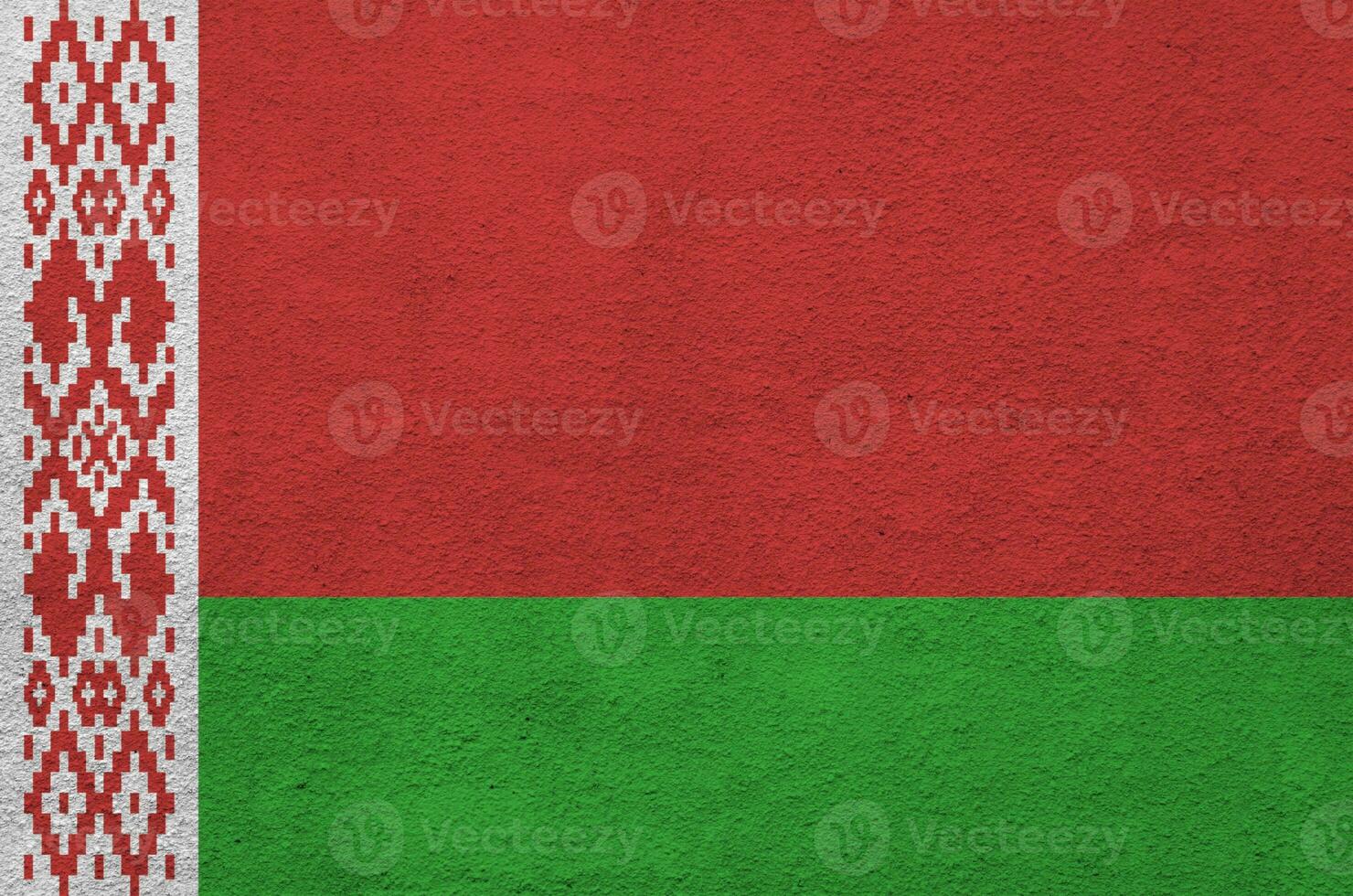 Belarus flag depicted in bright paint colors on old relief plastering wall. Textured banner on rough background photo
