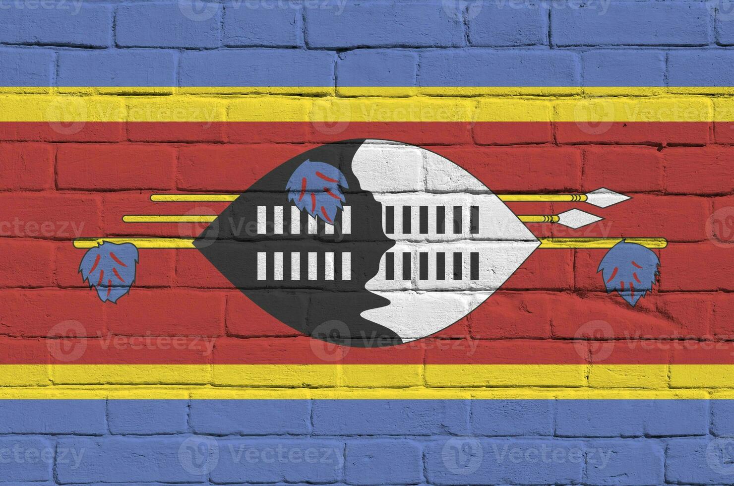 Swaziland flag depicted in paint colors on old brick wall. Textured banner on big brick wall masonry background photo