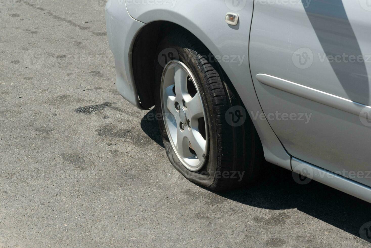 Close-up view of front flat car tire. photo