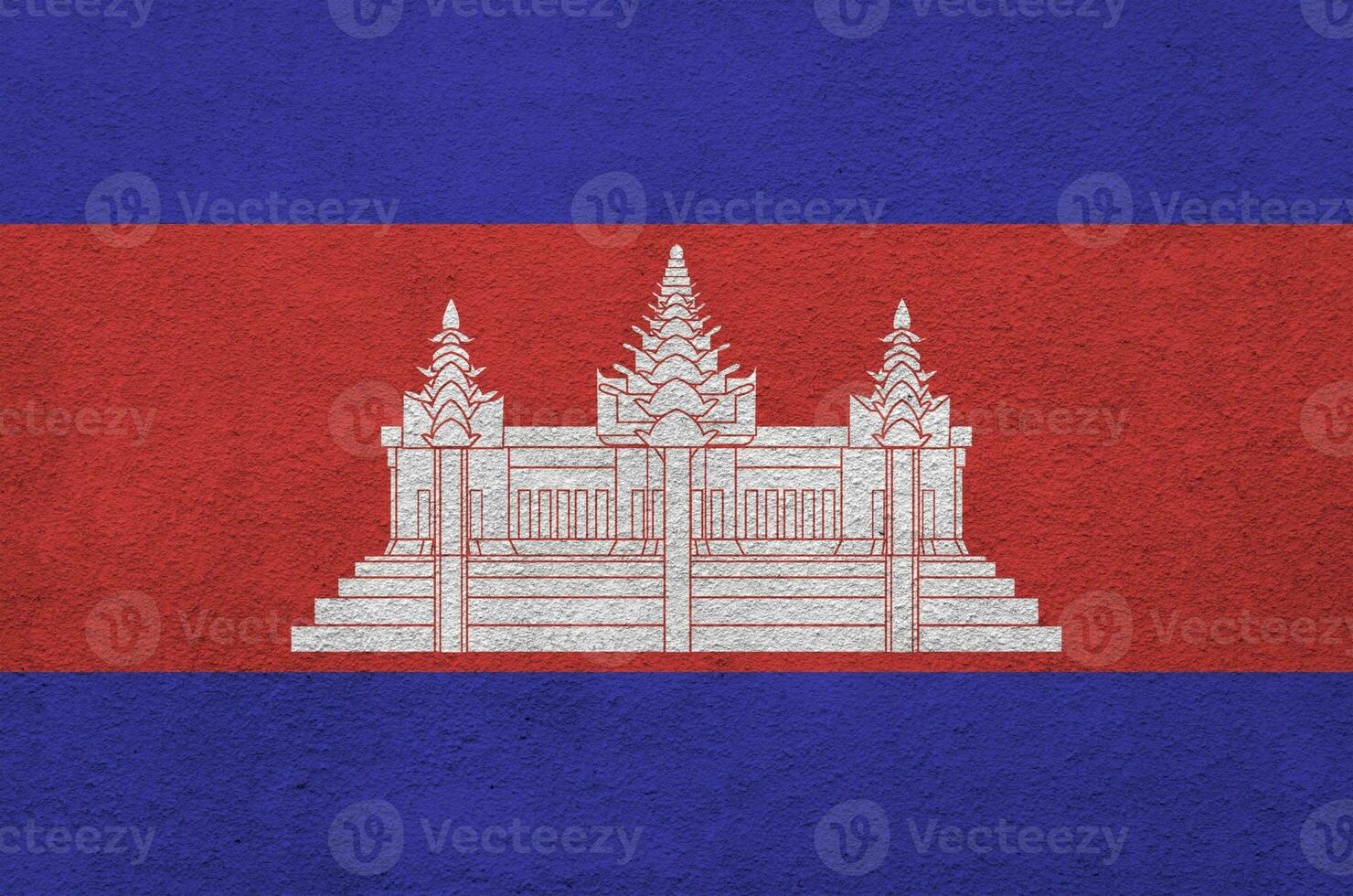 Cambodia flag depicted in bright paint colors on old relief plastering wall. Textured banner on rough background photo