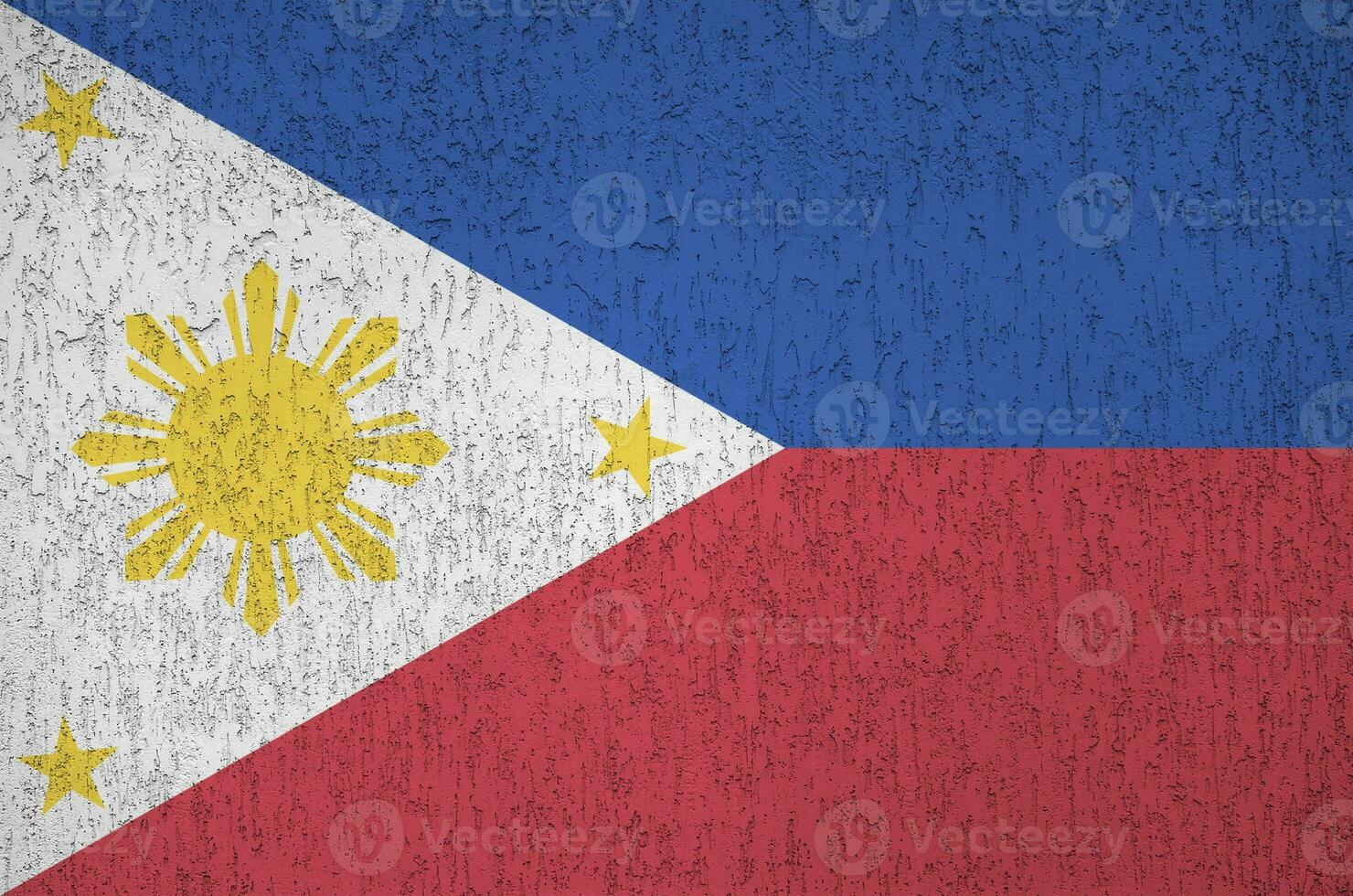 Philippines flag depicted in bright paint colors on old relief plastering wall. Textured banner on rough background photo