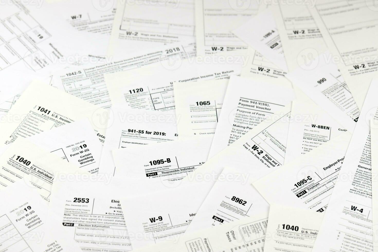 Many tax form blanks lies on table. Tax payers paperwork routine and bureaucracy concept. Need help with tax problems photo