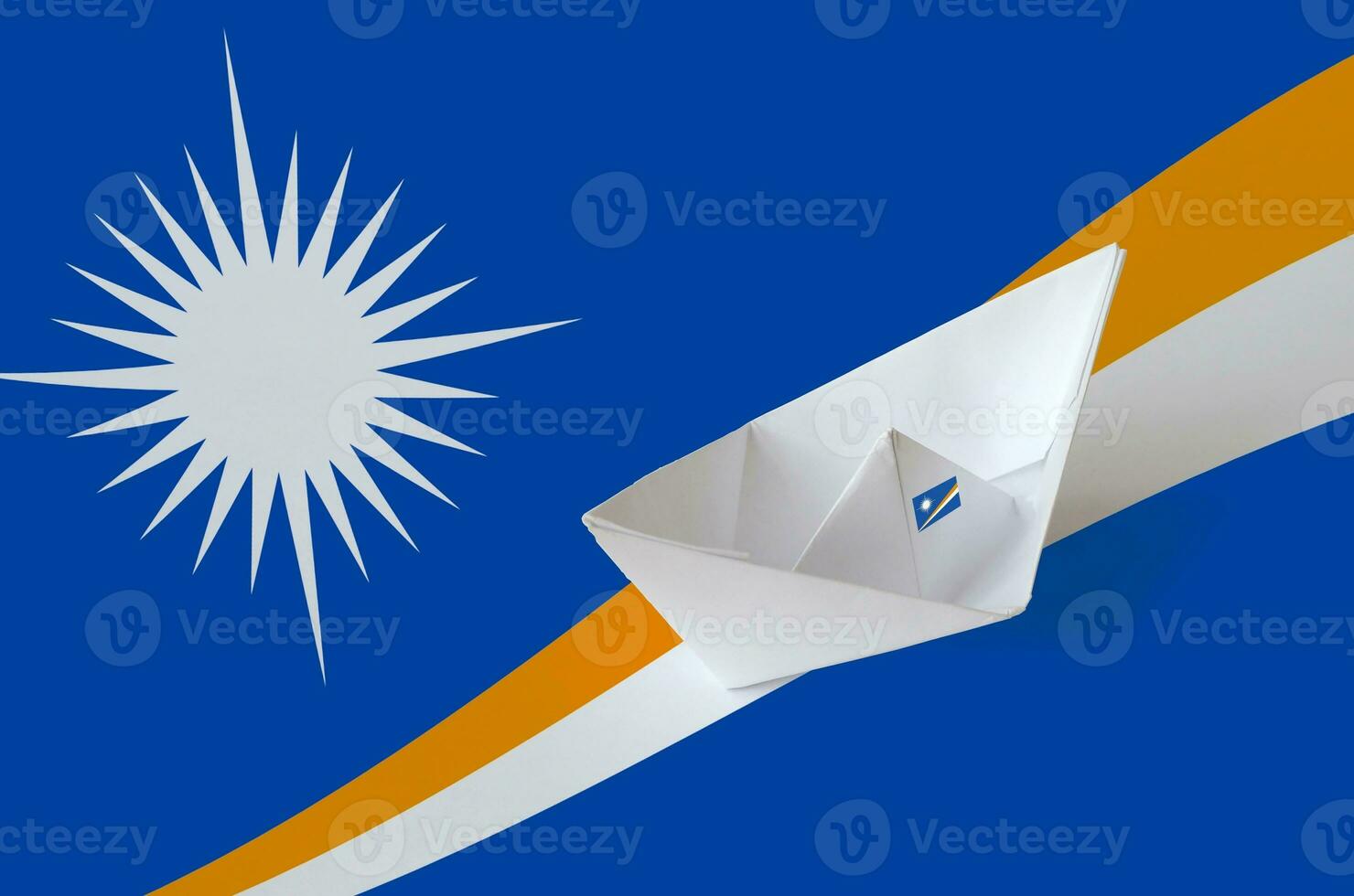 Marshall Islands flag depicted on paper origami ship closeup. Handmade arts concept photo