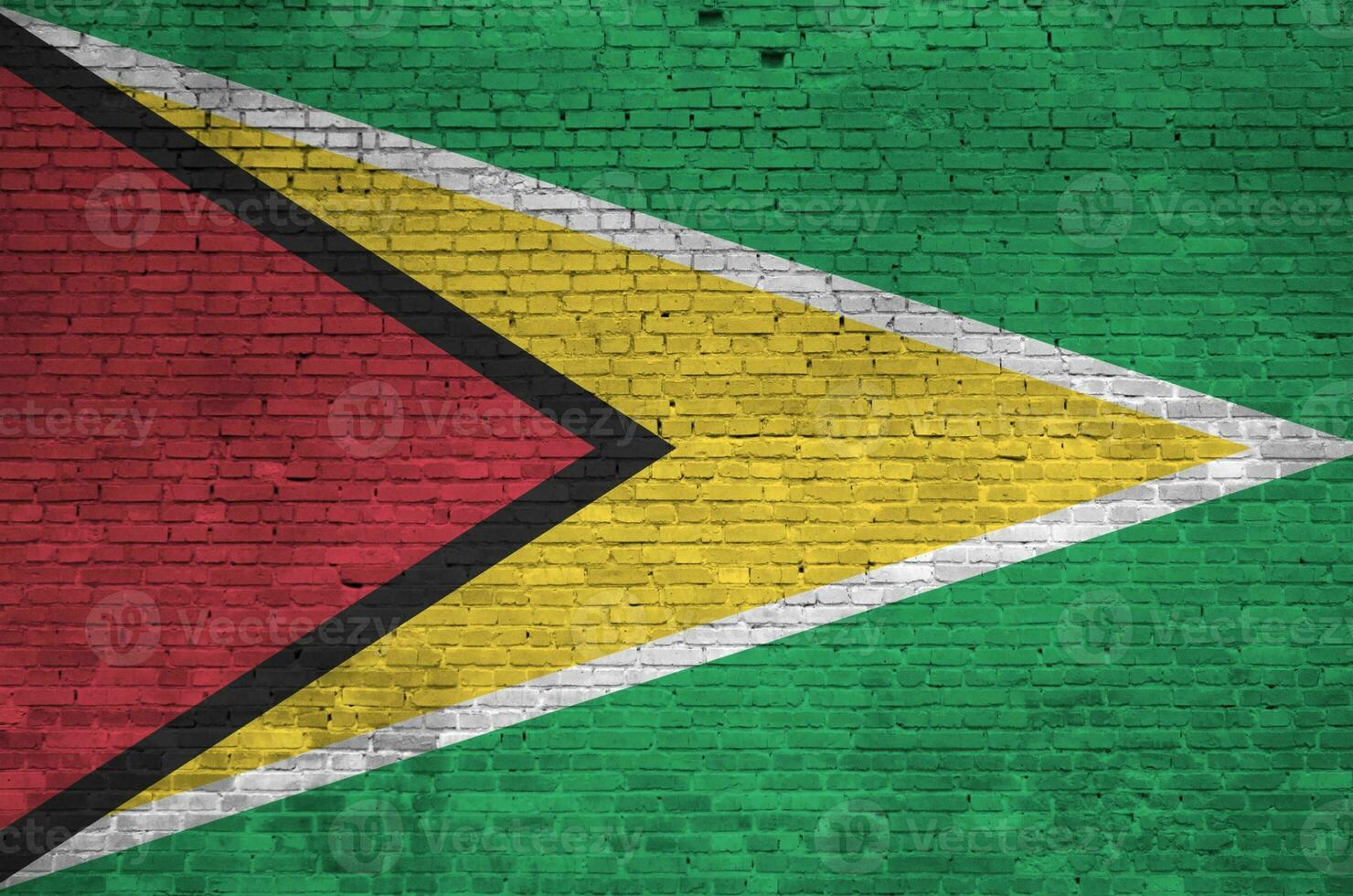 Guyana flag depicted in paint colors on old brick wall. Textured banner on big brick wall masonry background photo