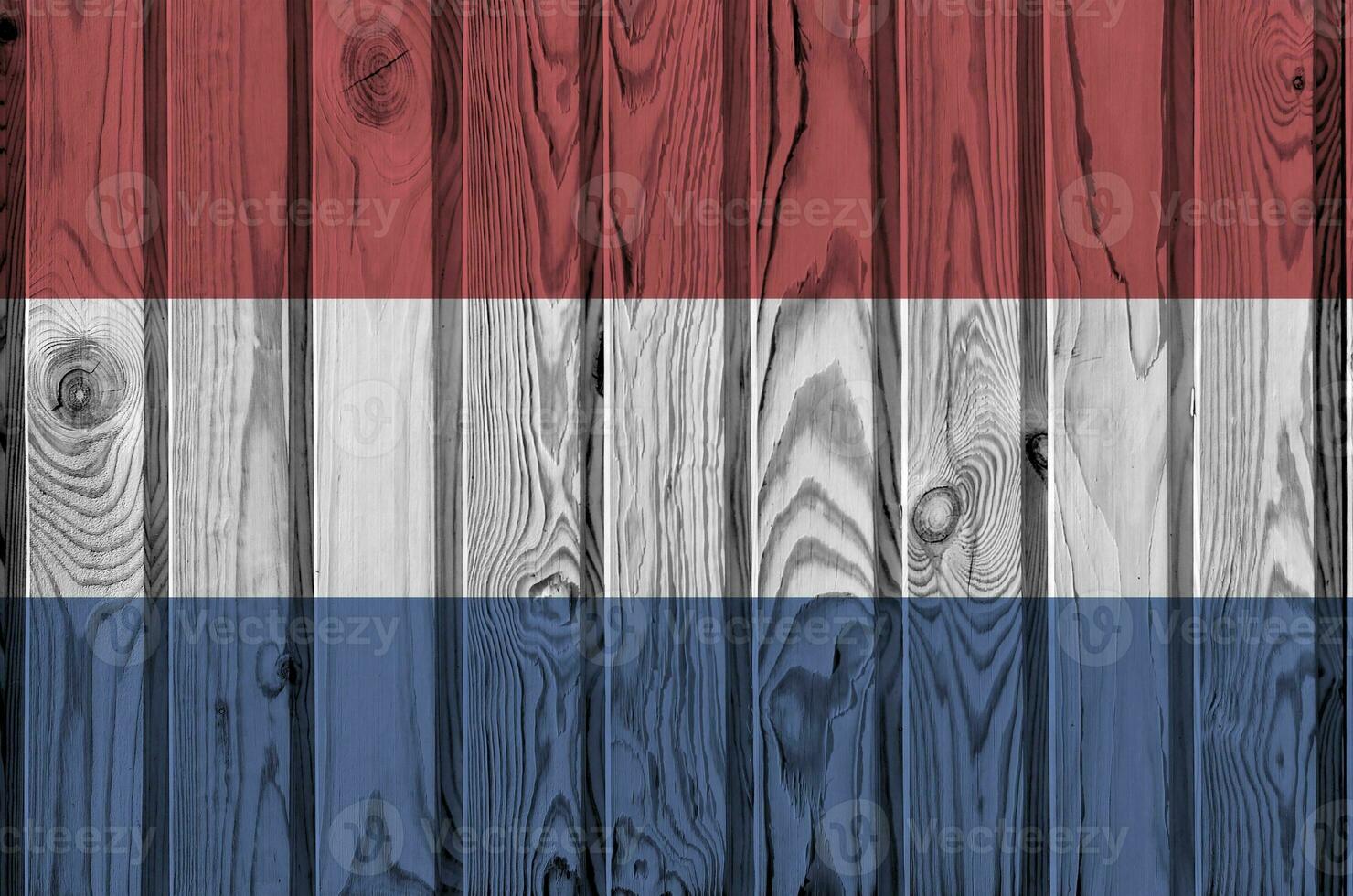 Netherlands flag depicted in bright paint colors on old wooden wall. Textured banner on rough background photo