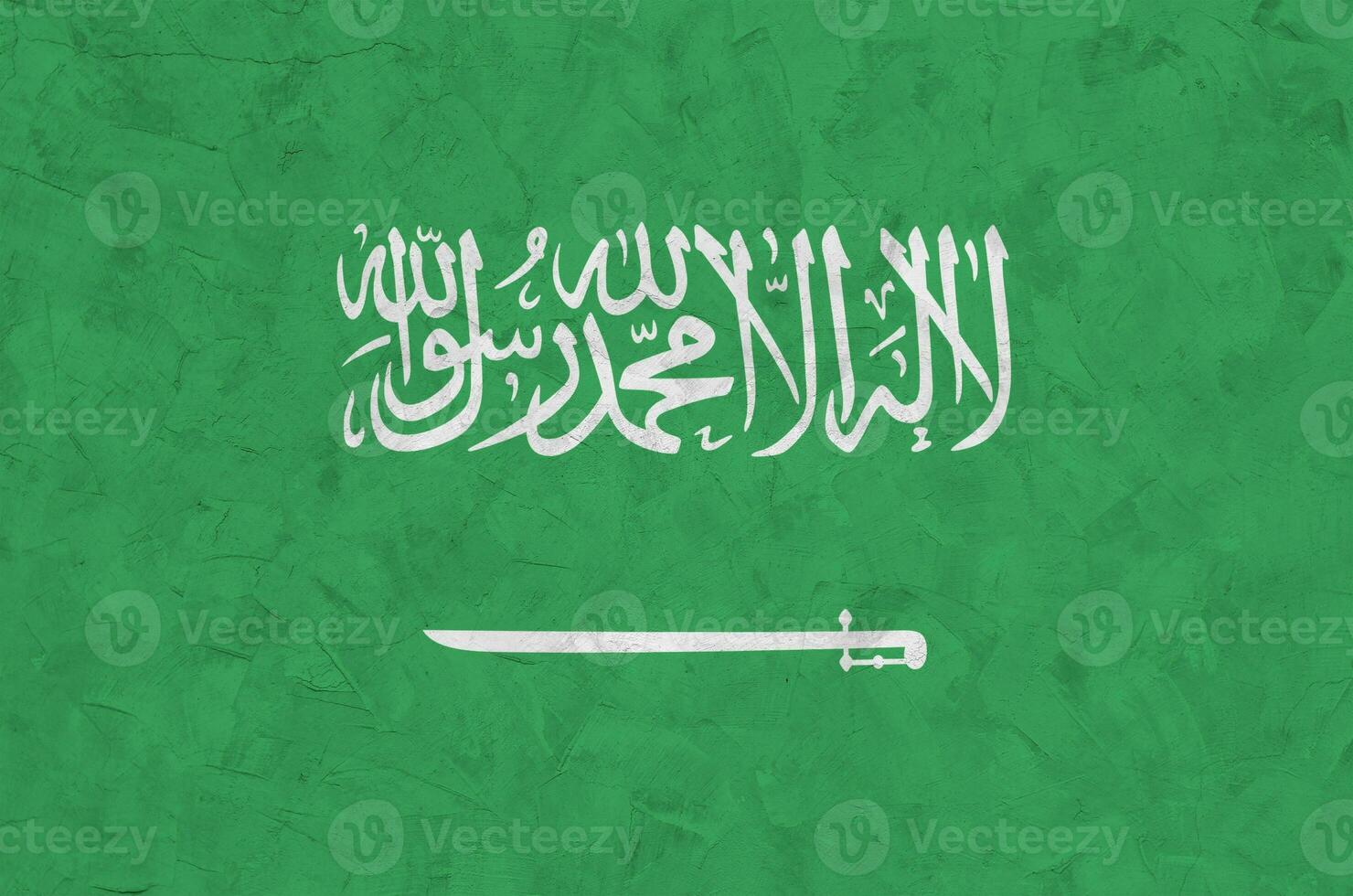 Saudi Arabia flag depicted in bright paint colors on old relief plastering wall. Textured banner on rough background photo