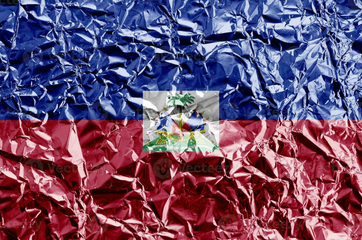 Haiti flag depicted in paint colors on shiny crumpled aluminium foil closeup. Textured banner on rough background photo