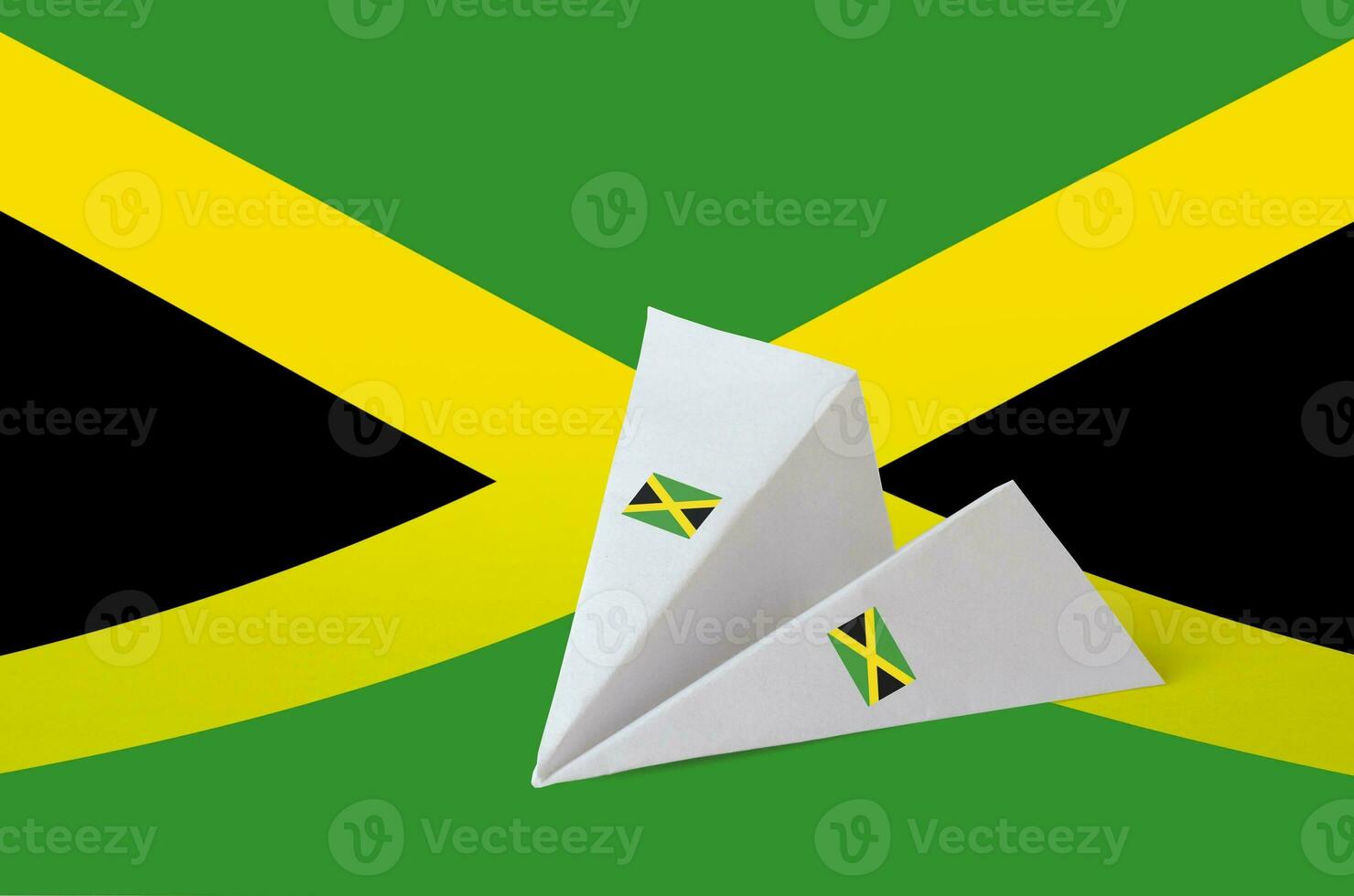 Jamaica flag depicted on paper origami airplane. Handmade arts concept photo