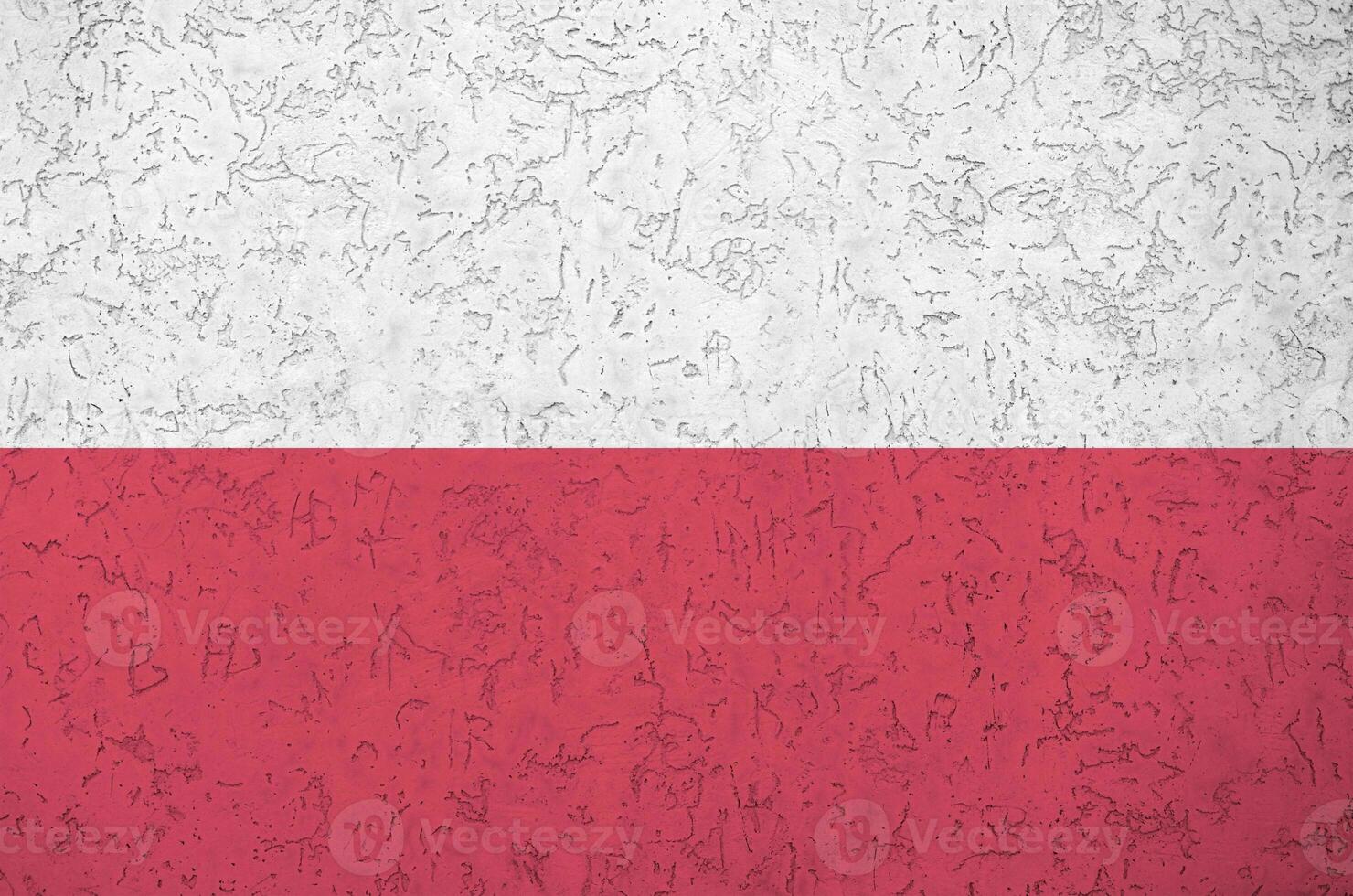 Poland flag depicted in bright paint colors on old relief plastering wall. Textured banner on rough background photo