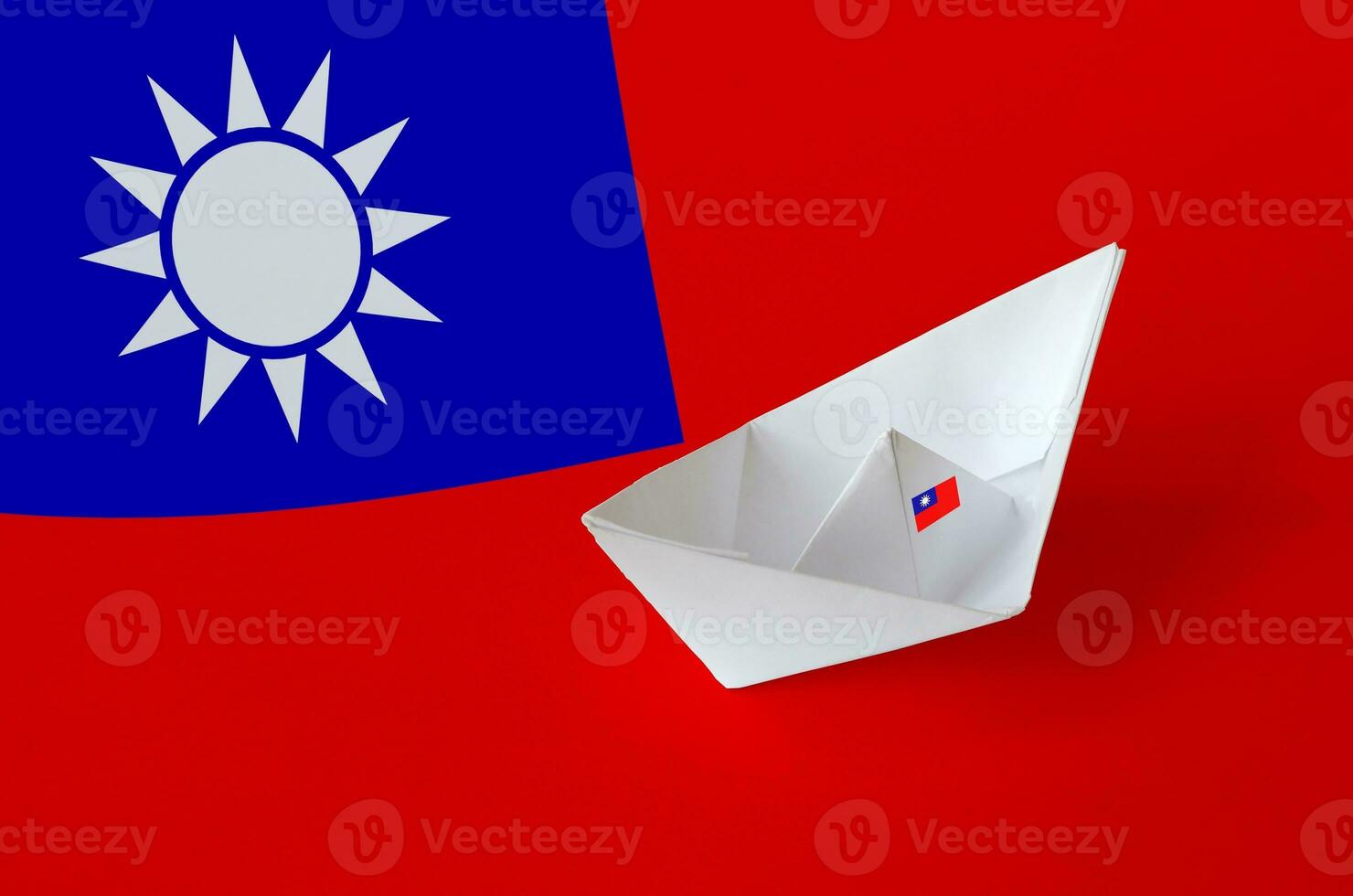 Taiwan flag depicted on paper origami ship closeup. Handmade arts concept photo