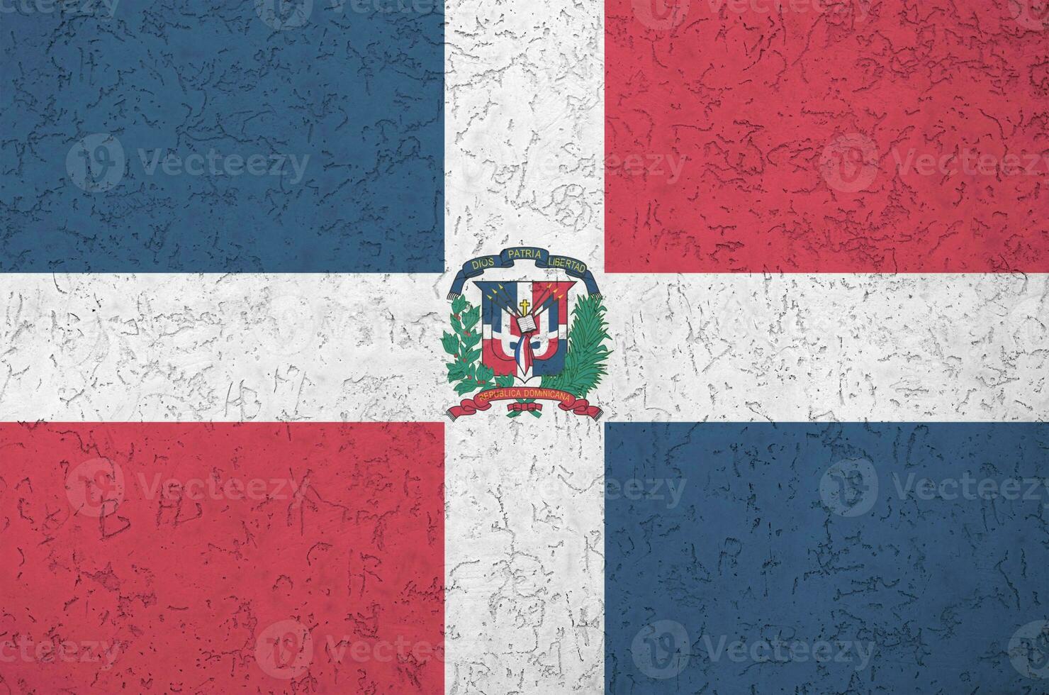 Dominican Republic flag depicted in bright paint colors on old relief plastering wall. Textured banner on rough background photo