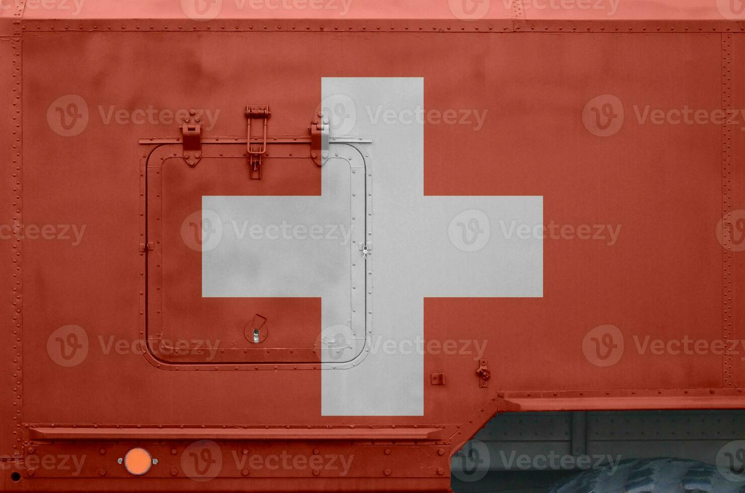 Switzerland flag depicted on side part of military armored truck closeup. Army forces conceptual background photo