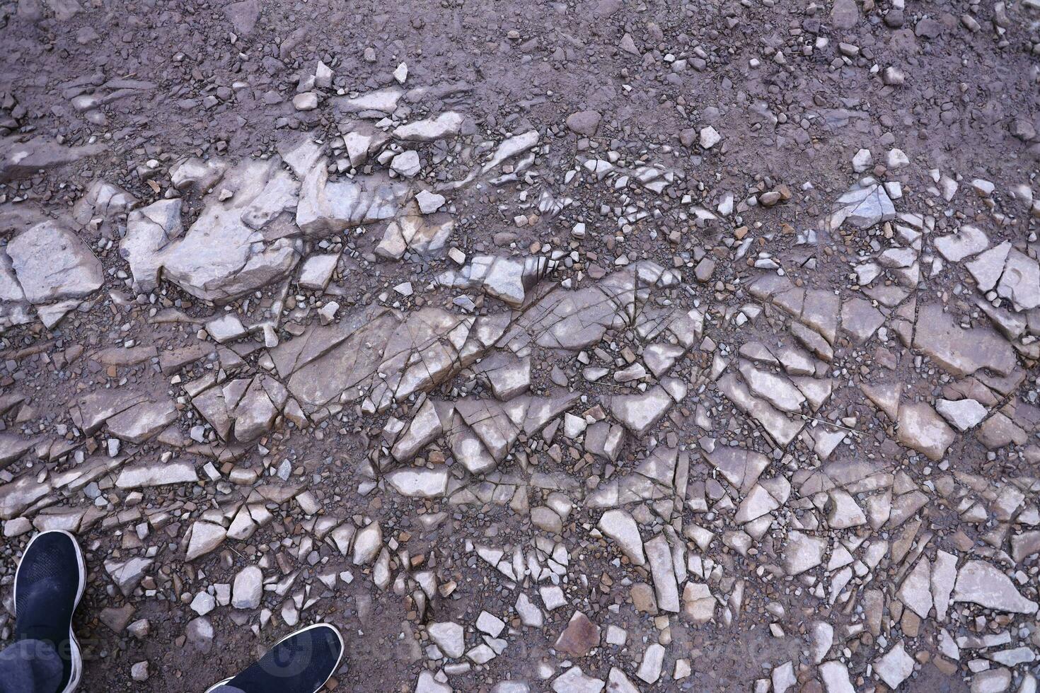Background of shattered stony stones surface in mountain area. Texture with natural light photo