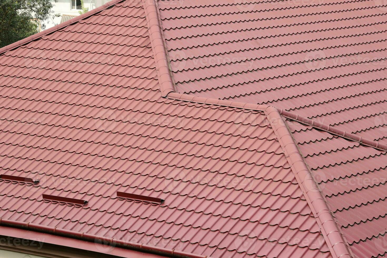 Decorative metal roof tiles in shape of old shingles. Type of roof of the house from a metal profile photo