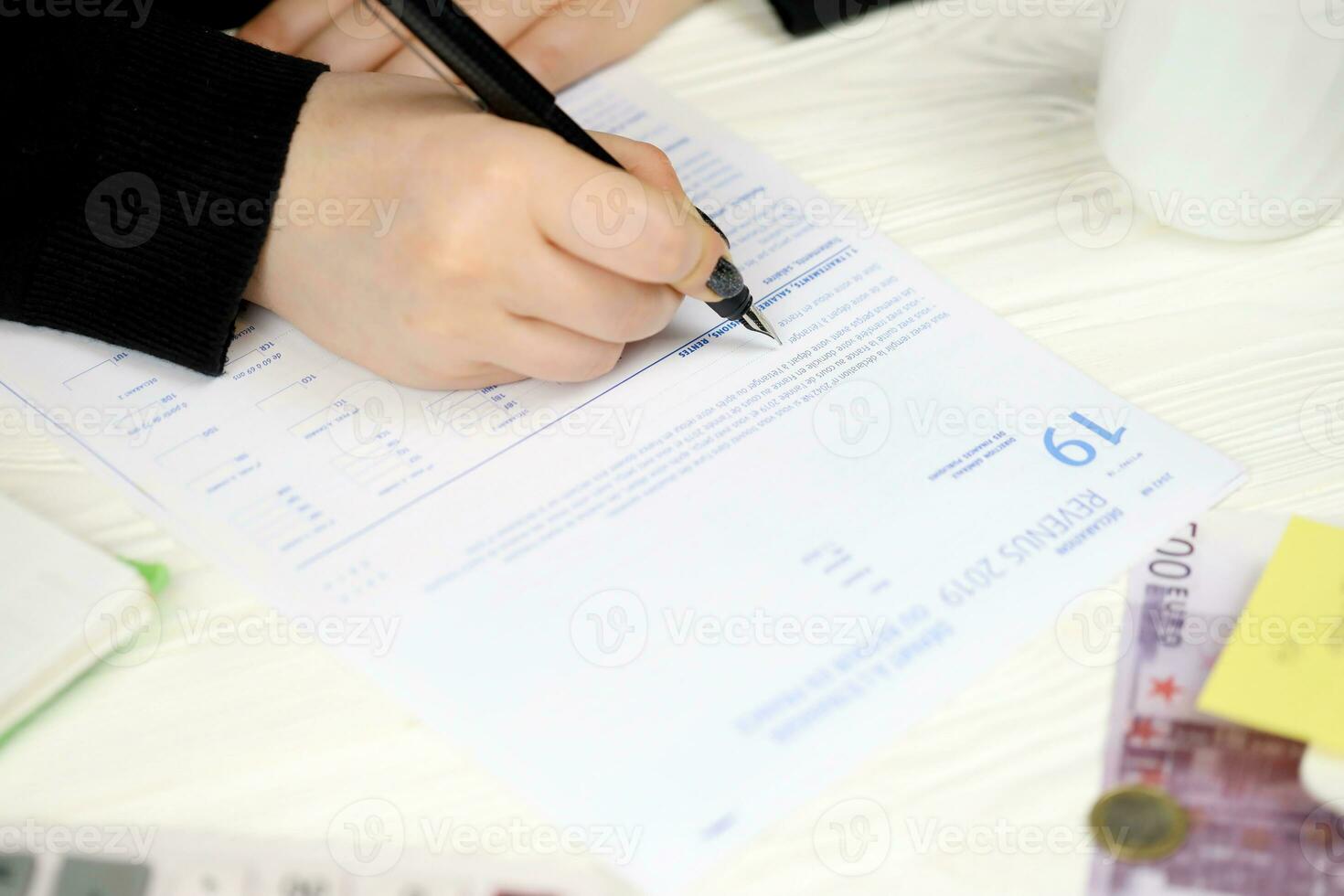Accountant fill french tax form 2042 NR departure abroad or return to France in end of tax period. Taxation and paperwork routine photo