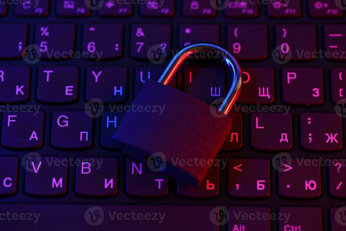 Computer security concept with a closed padlock on the keyboard. Padlock on top of a laptop keyboard. Selective focus photo