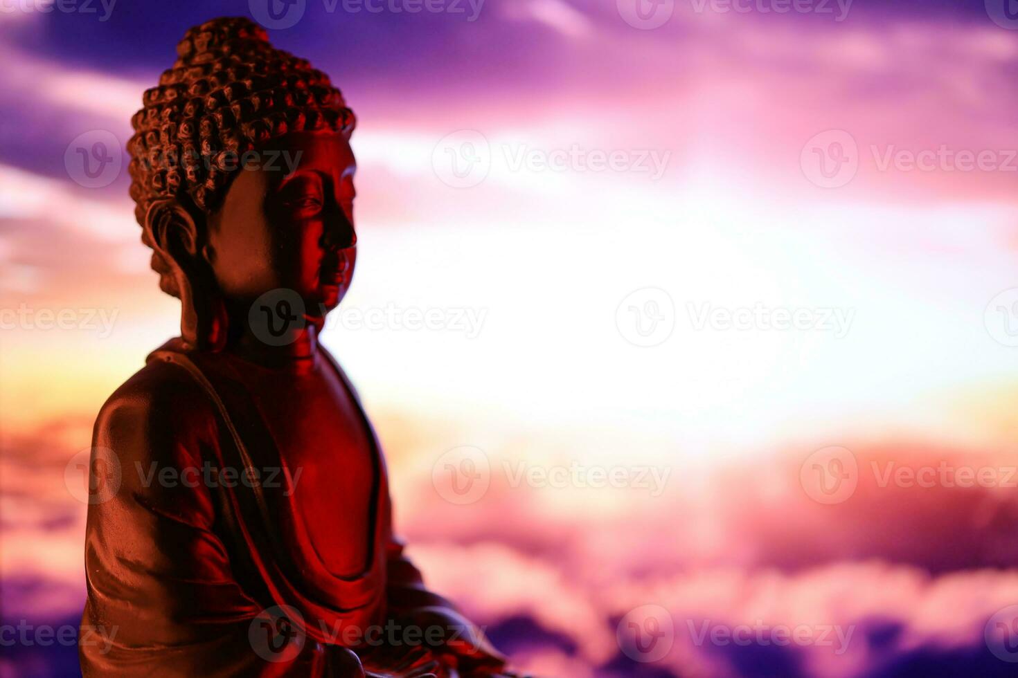 Buddha Purnima and Vesak day concept, Buddha statue with low key light against beautiful and colorful background. Meditation photo
