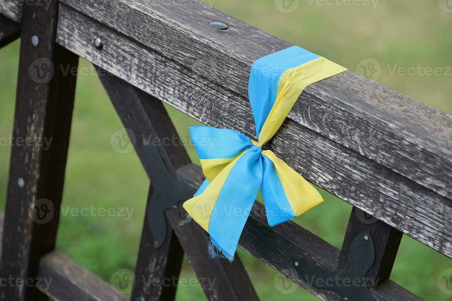 Ribbons in the colors of the national flag of Ukraine are tied to the handrail photo