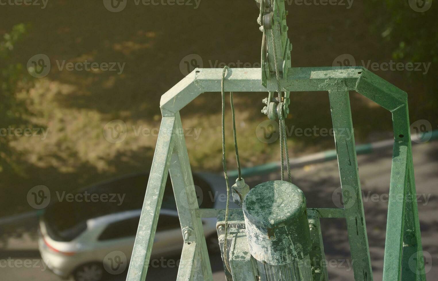 Hoist supply and safety lock as part of suspended wire rope platform for facade works on high multistorey buildings. Hoist for elevation, raising or lifting cradle photo
